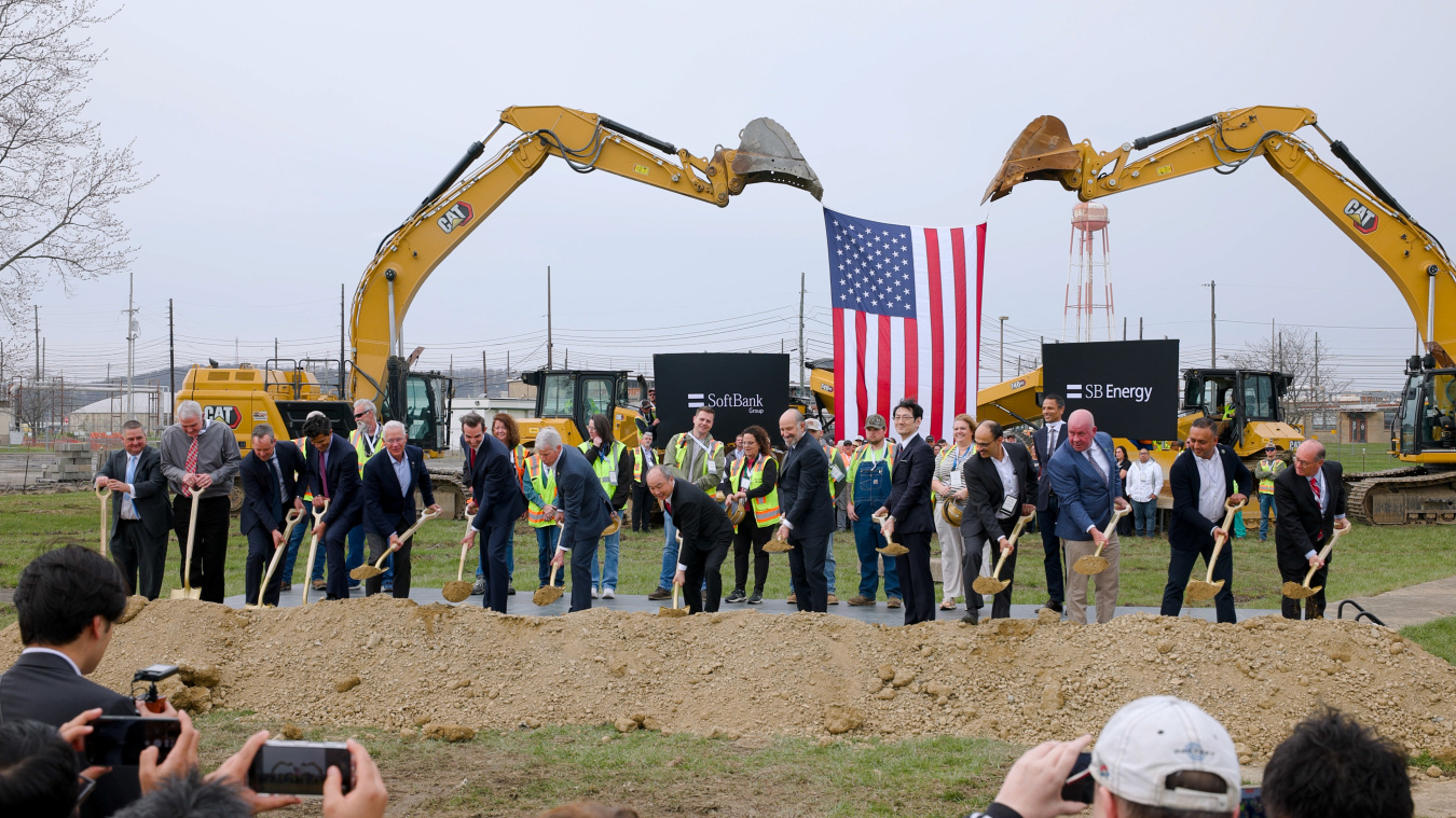 A group of professionals holding shovels while participating in a groundbreaking ceremony at the Portsmouth Side