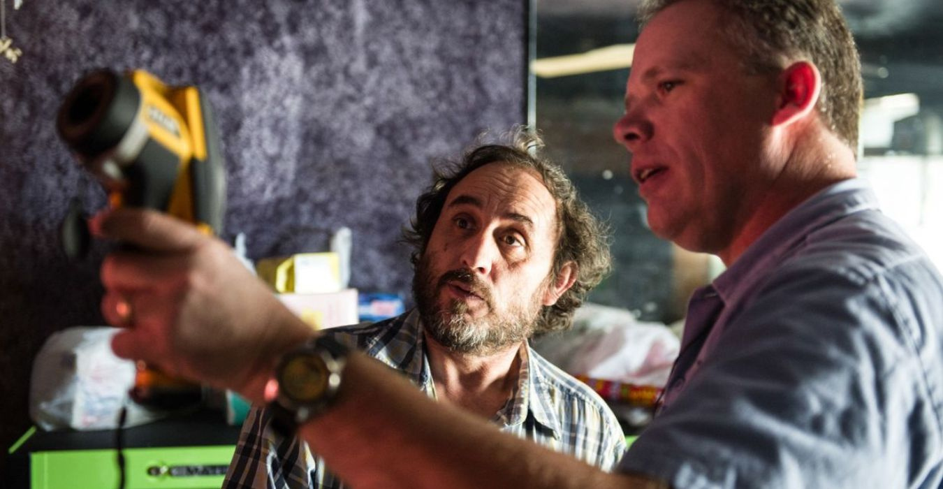 A home energy auditor explaining energy use readings to a home owner.