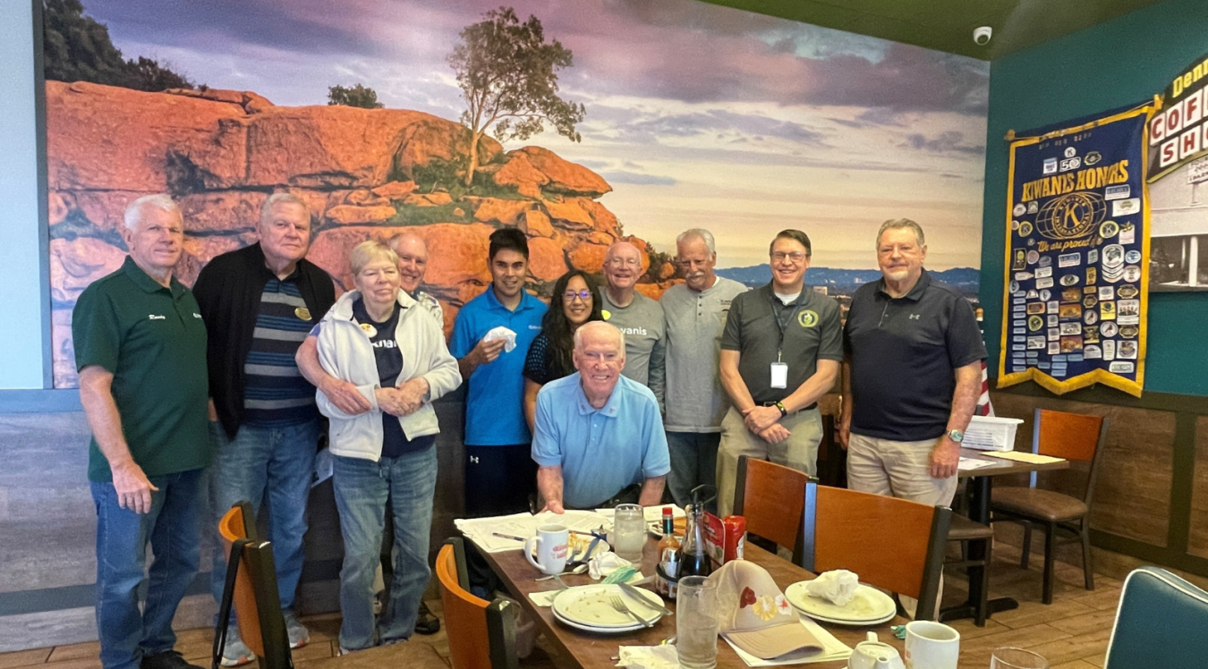 A group of individuals posing for a group picture inside a restaurant 