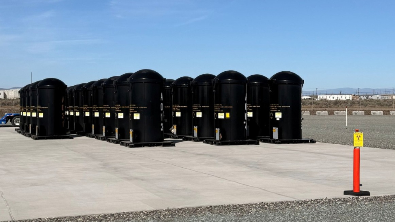 A group of 30 black waste containers outside at the Hanford Site