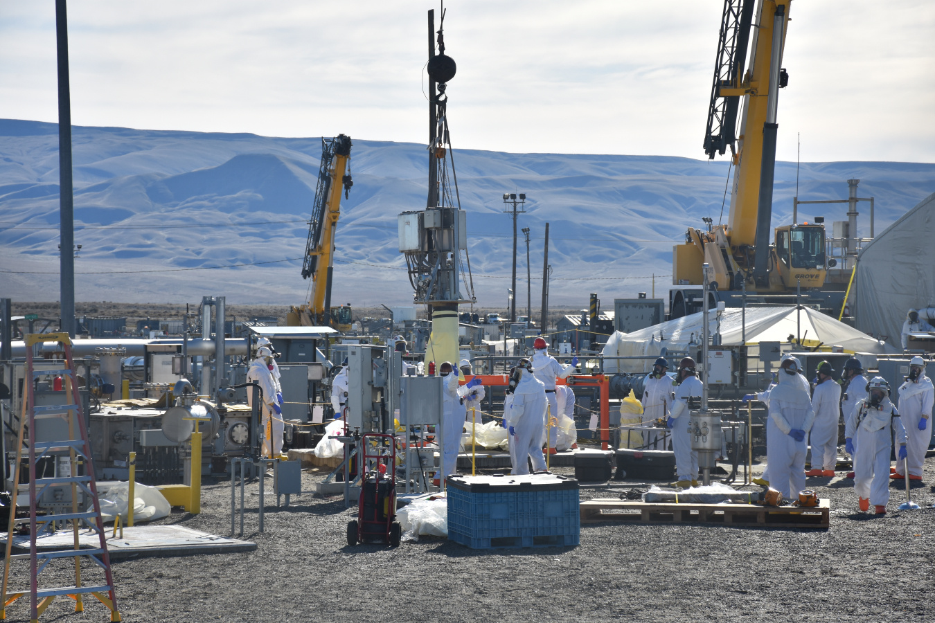 Hanford works removing part of a pump outside at a work site