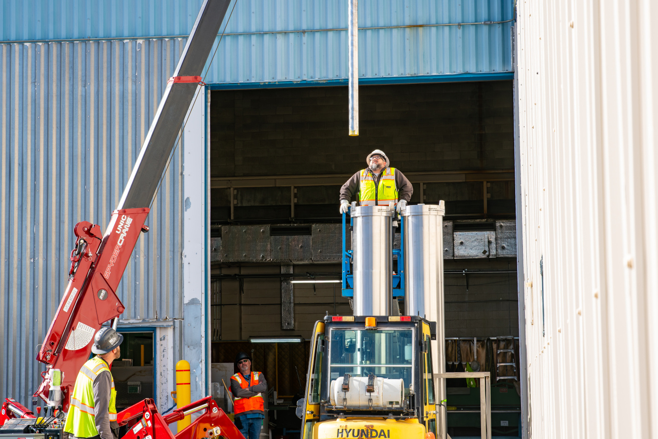 Crew members at the Idaho site using machinery to place metal rods