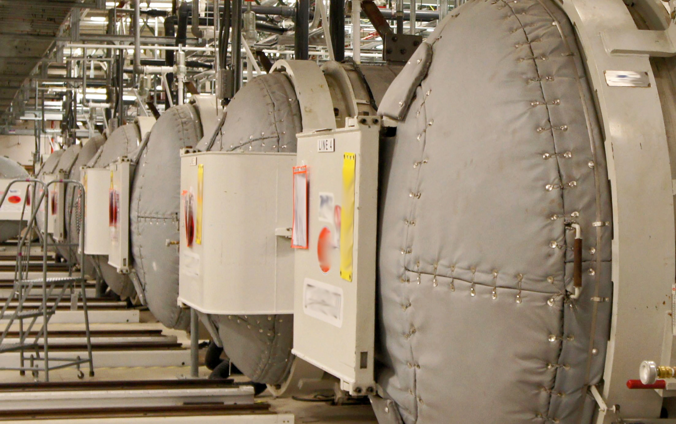 A room full of large grey autoclaves at the Portsmouth Paducah Project Office