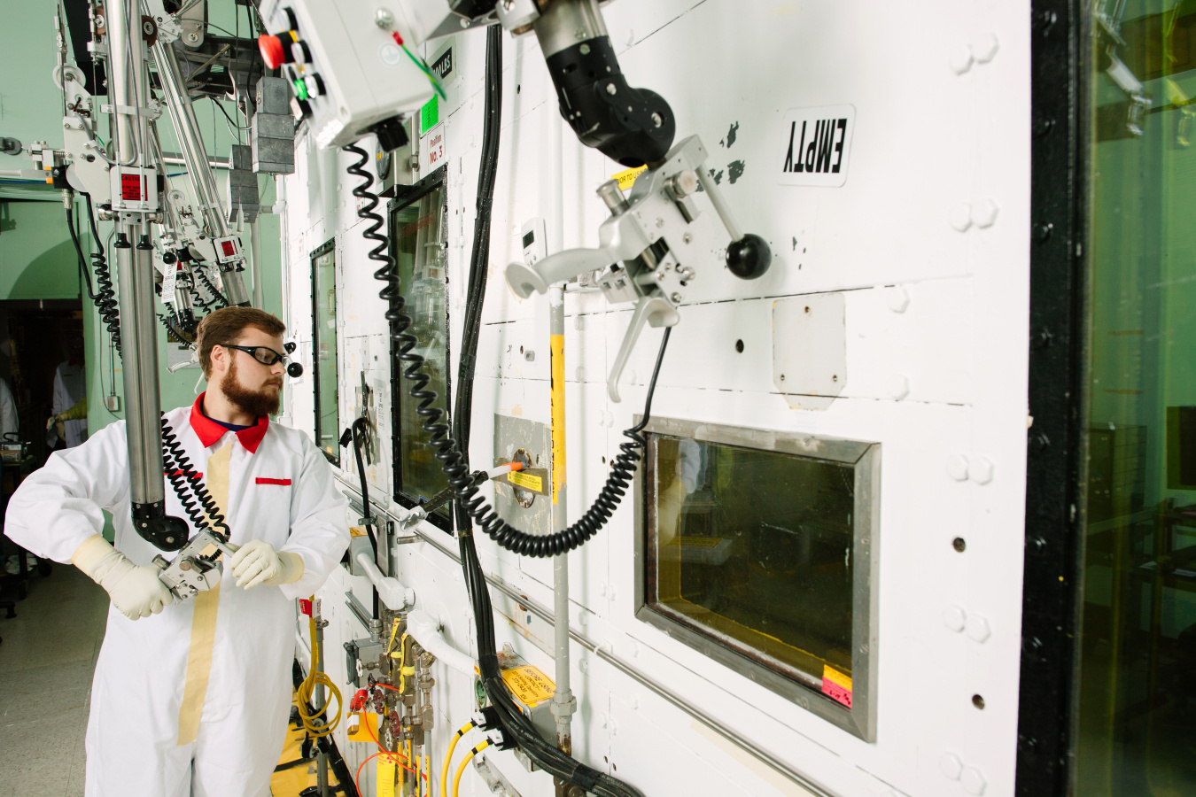 A scientist in a laboratory using a Mechanical Manipulator machine at the Hanford Site