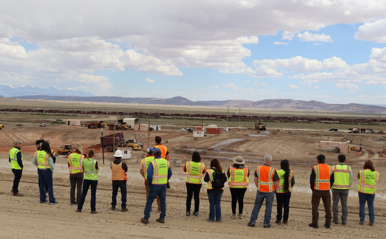 A group of people in safety vests touring the Moab Site