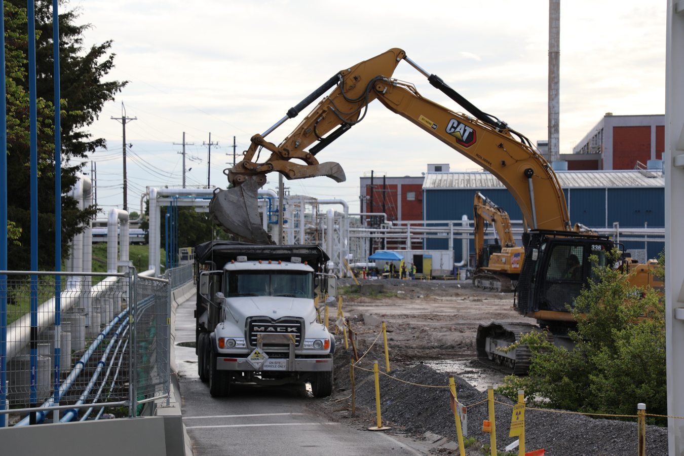 Construction vehicles and trucks removing debris from the Oak Ridge Site
