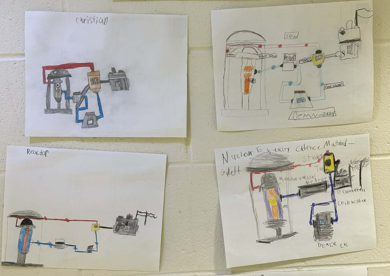 Four posters of drawings of nuclear reactors made by students