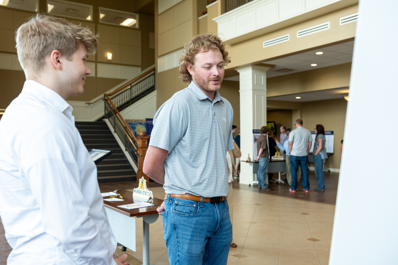 Two individuals speaking to each other at an Expo