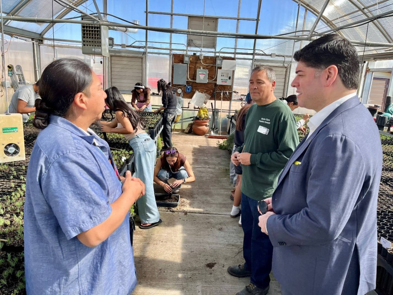 Indian Energy Director Mahroum, right, tours the Santa Fe Indian School’s greenhouse