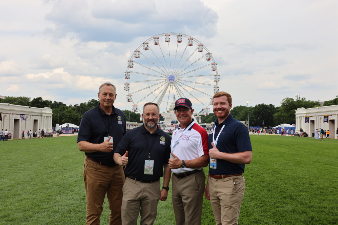 Four people in front of ferris wheel