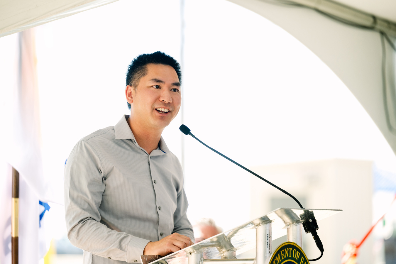 A man standing behind a podium speaking into a microphone