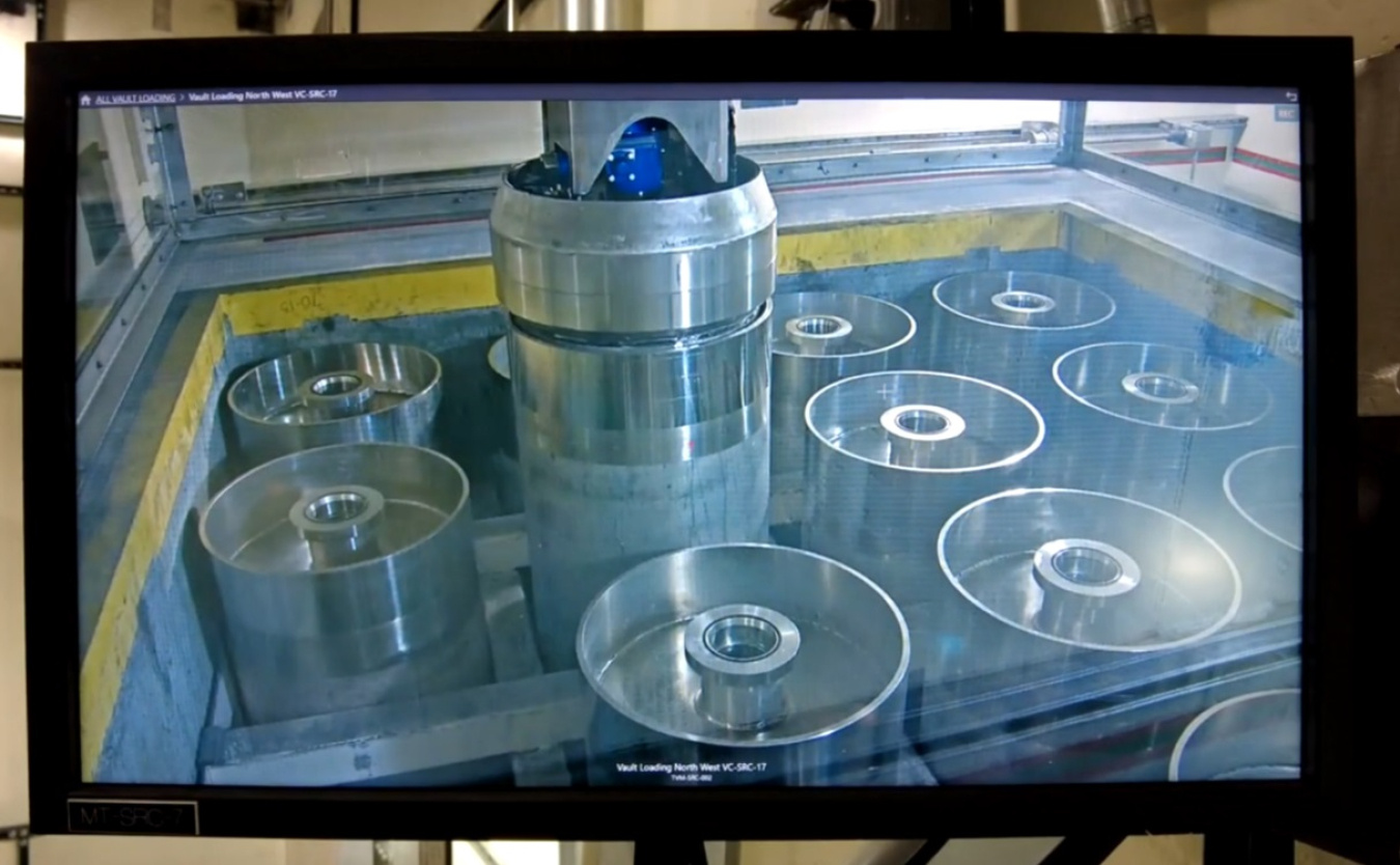Monitor displaying multiple metal tanks of waste