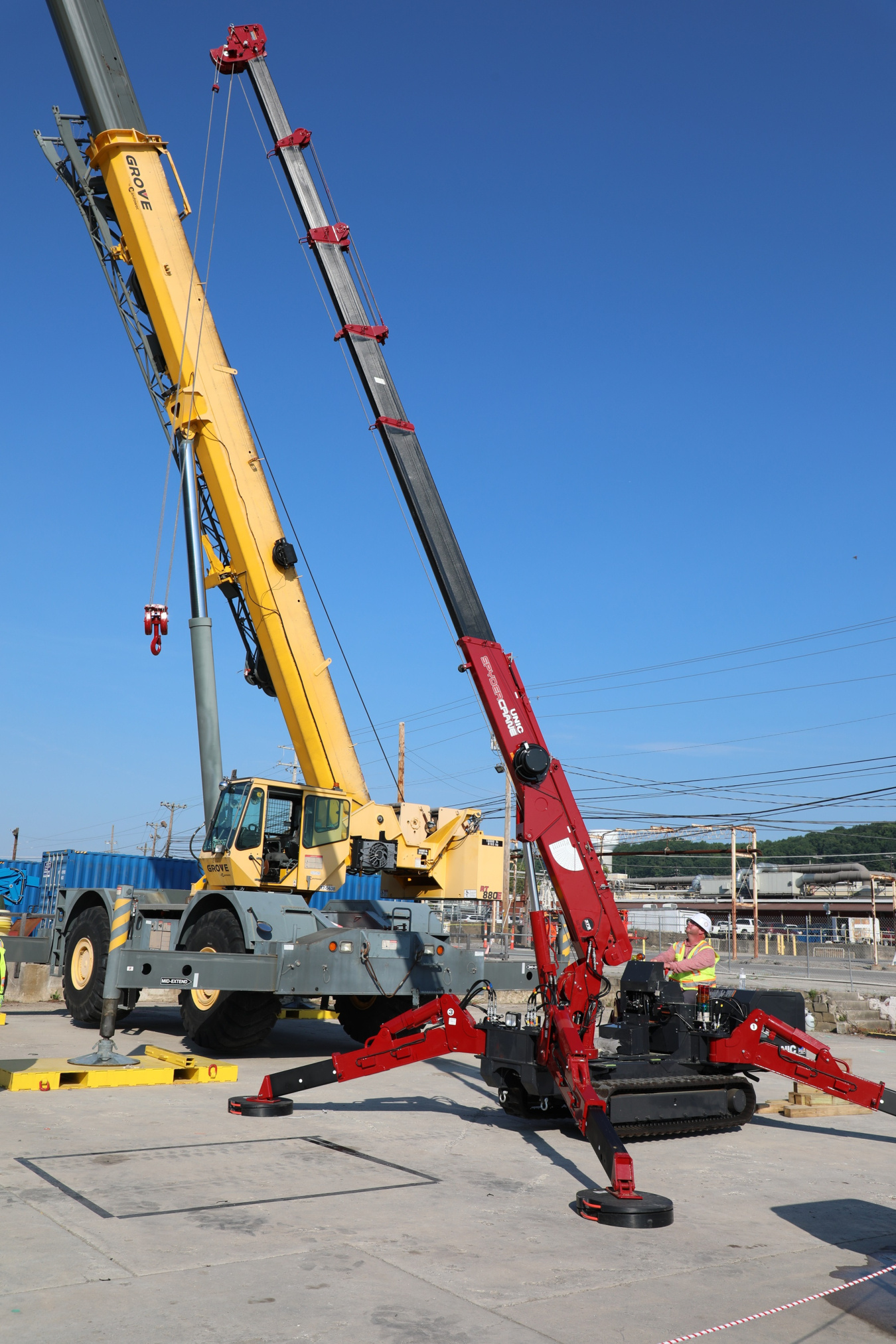 Two large cranes at the Oak Ridge site, one yellow and one red