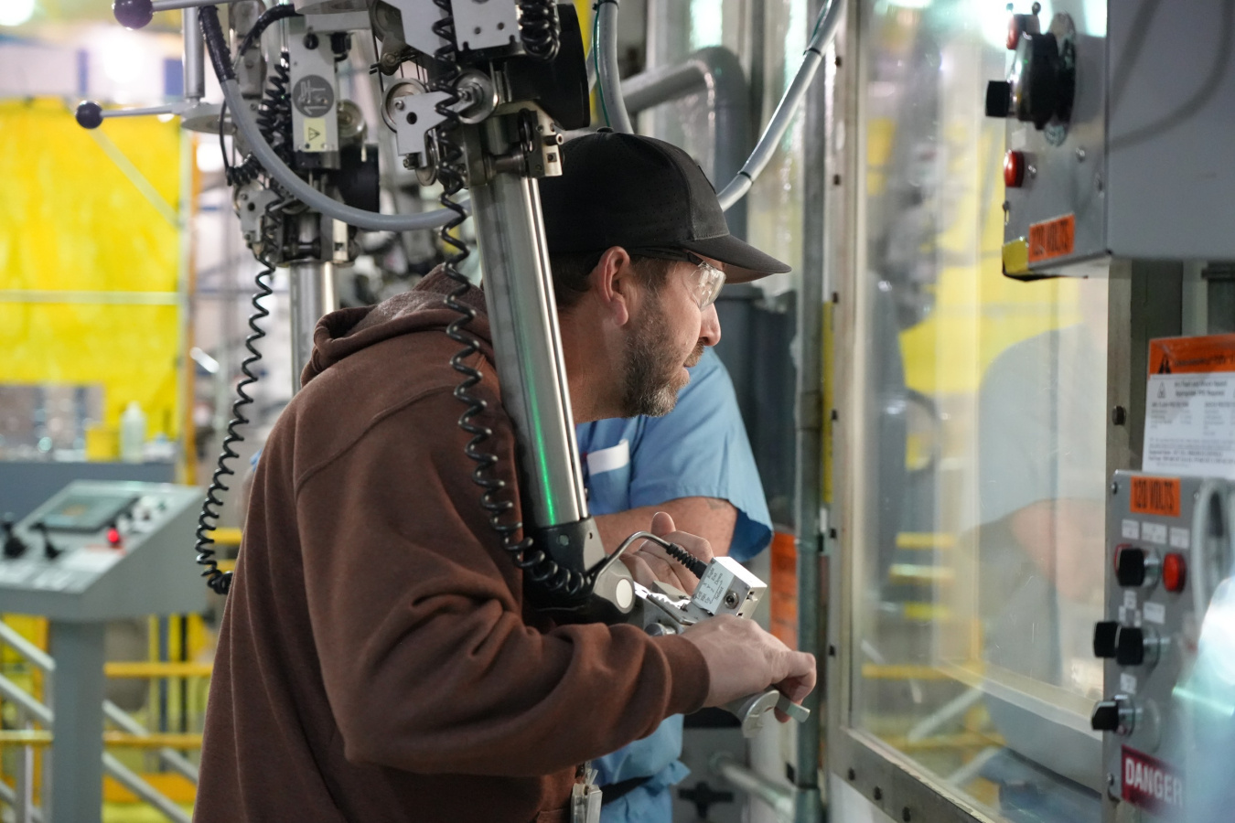 An employee operating a hot cell machine at the Oak Ridge Site