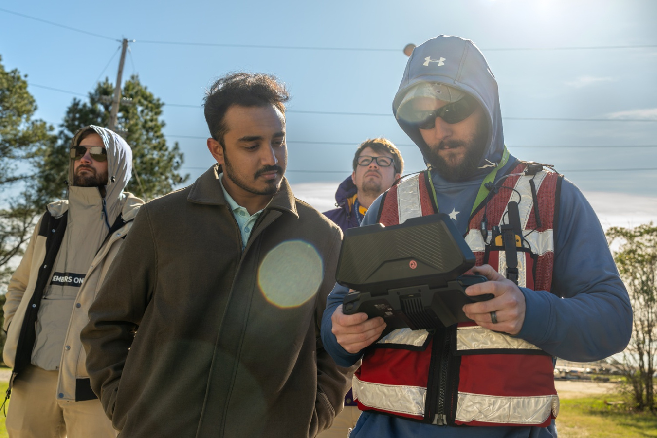A group of employees looking at a monitor for a drone at the Savannah River Site