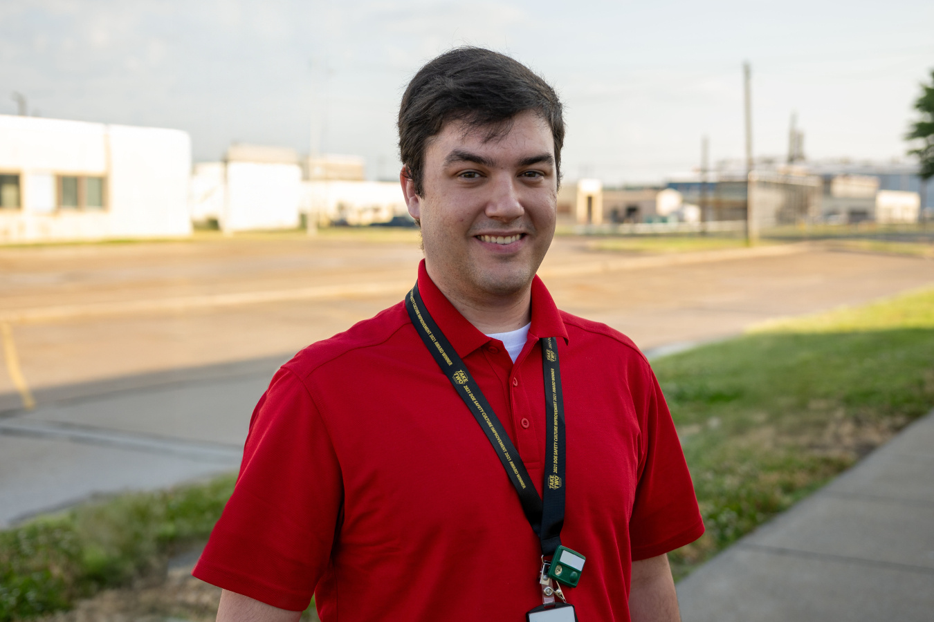 Professional photo of a worker at the Paducah site in a red shirt