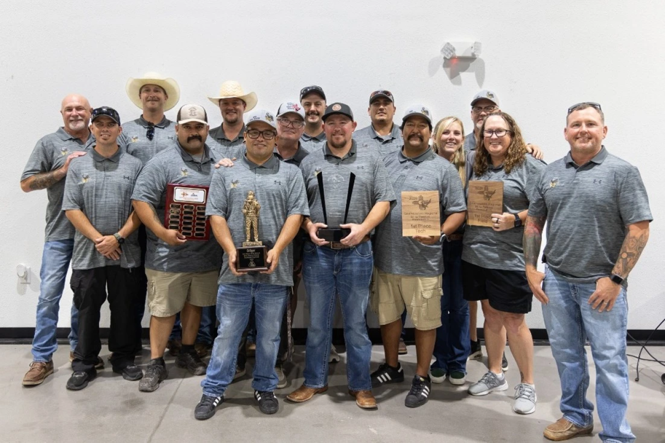 A group of WIPP employees posing for a group photo holding awards