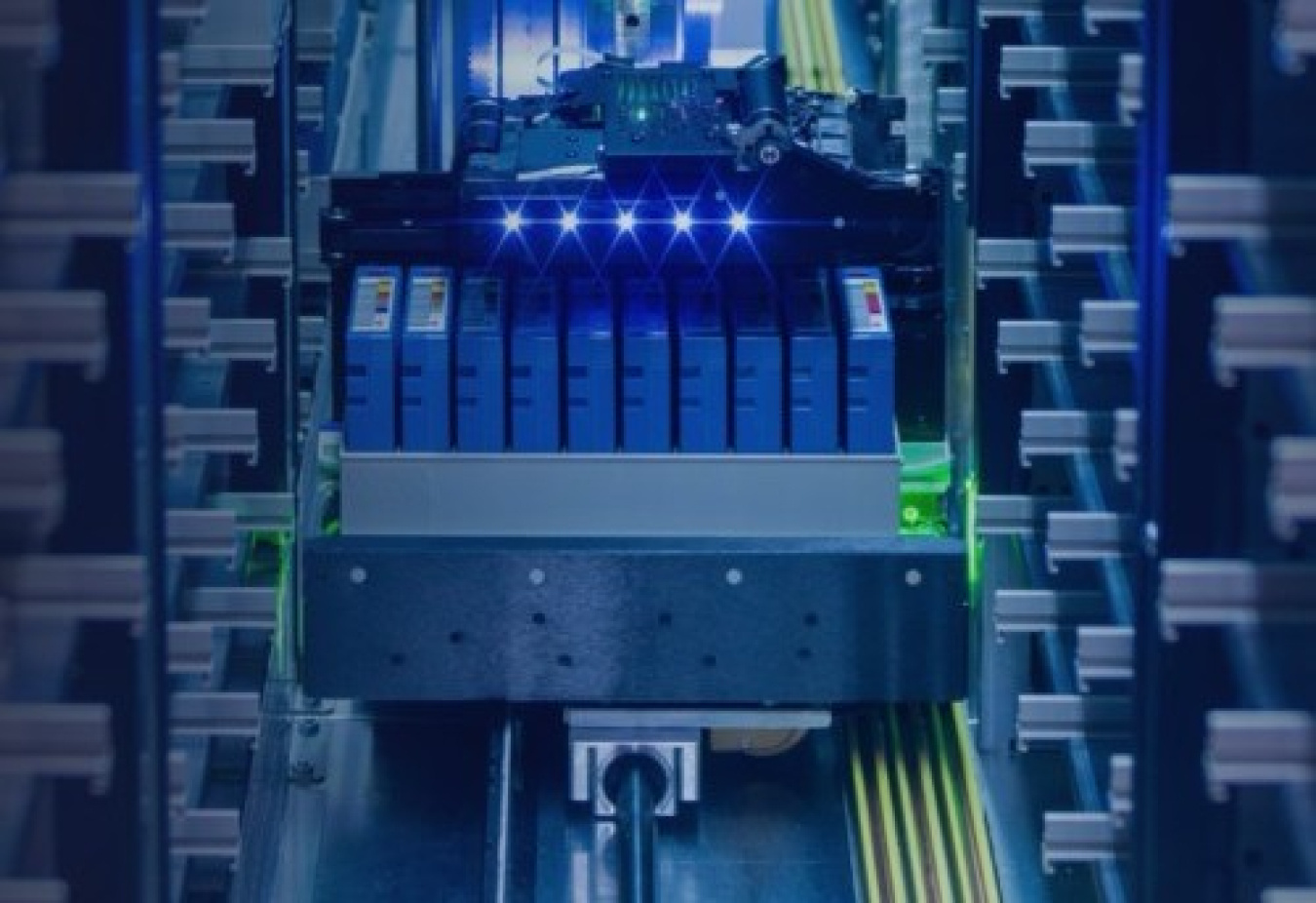 Automated data storage system with a robotic mechanism moving between rows of server equipment illuminated by blue lights.