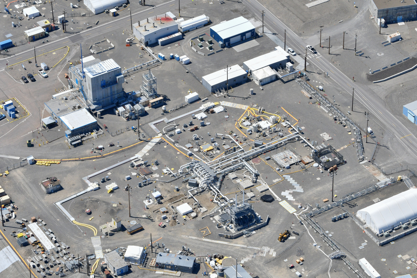 Aerial view of a tank farm at the Hanford Site with lots of buildings and pavement