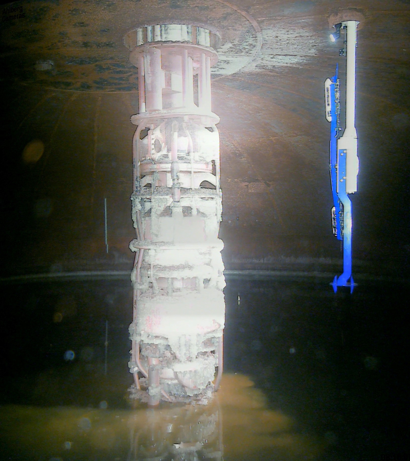 A large white cylinder shape mixer inside a large waste tank at the Hanford Site