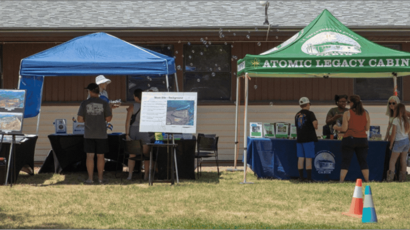 Rotating set of images of booths set up outside at a celebration event at the Moab Site