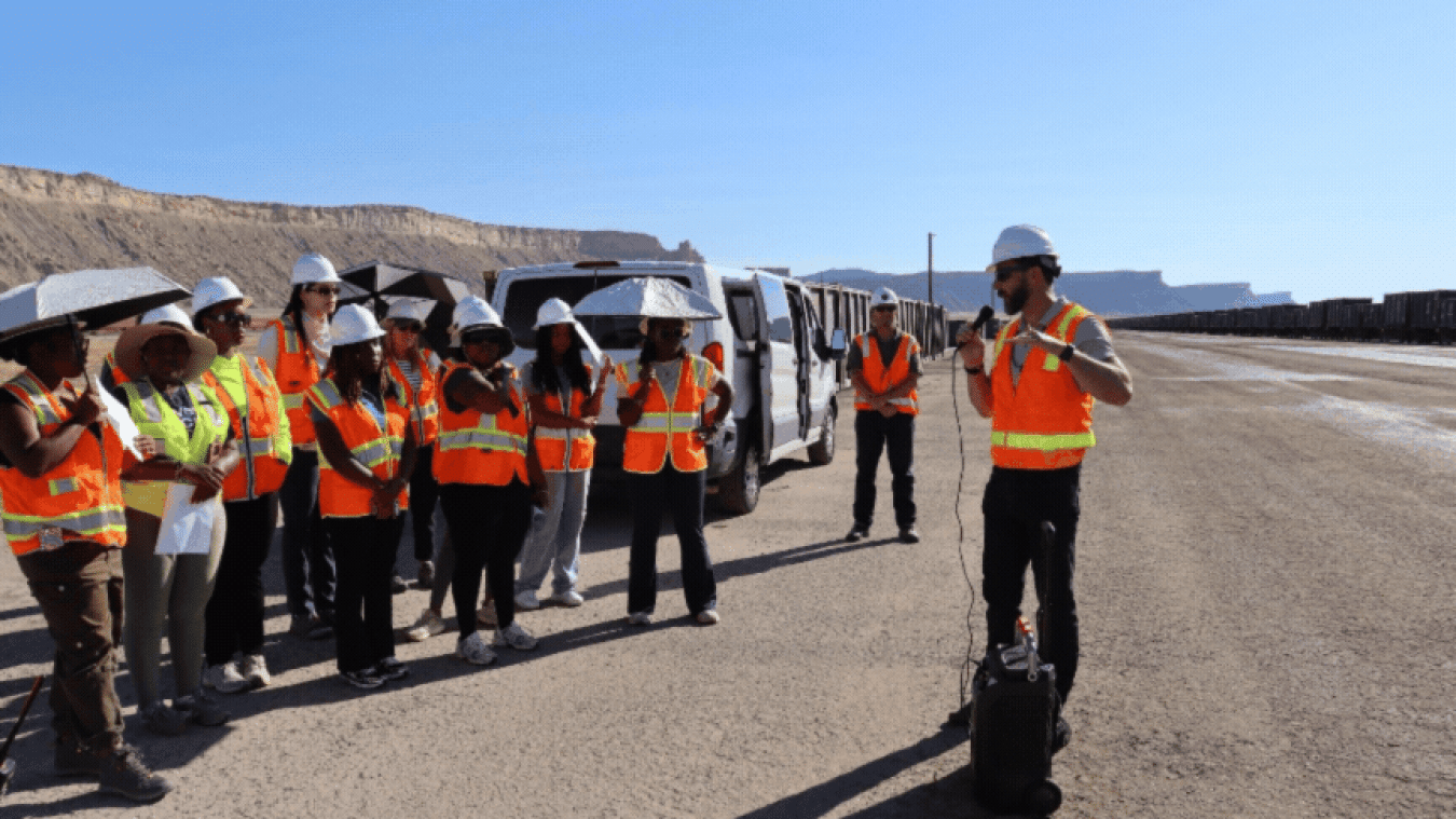 A rotating set of images of interns and employees in orange safety vests touring the Moab Site