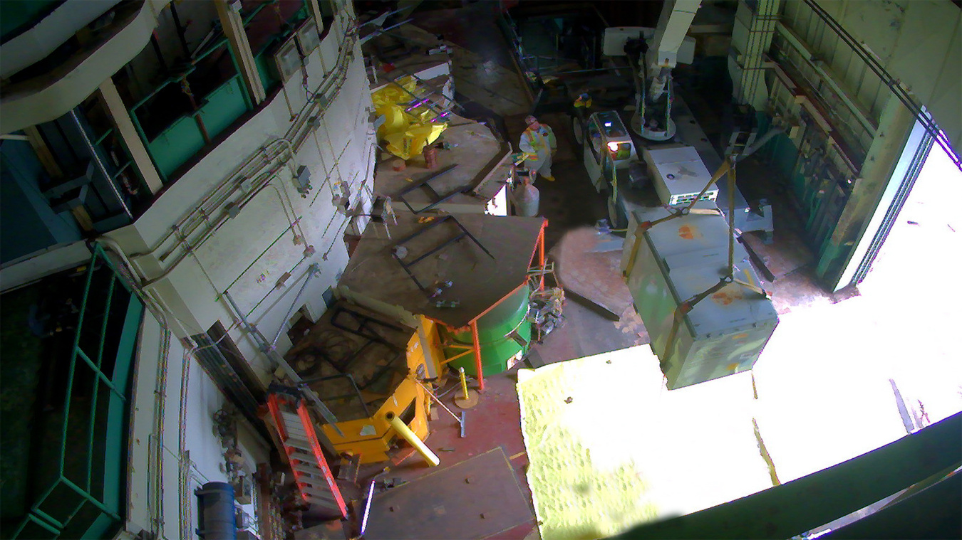 Overhead view of a facility building with a tank being lifted into the air