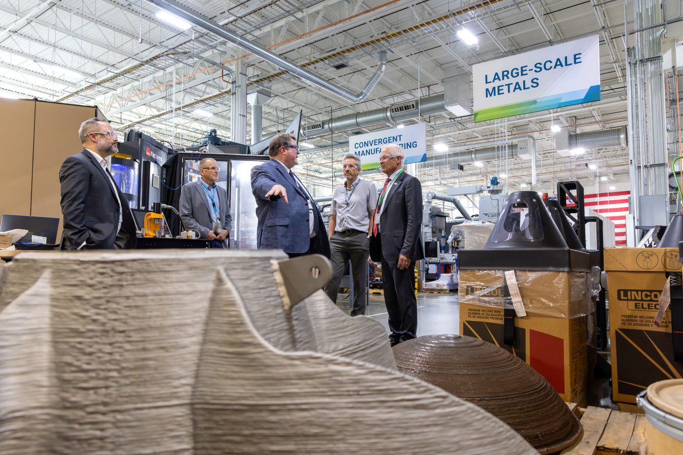 A group of professionals taking a tour of a large building 
