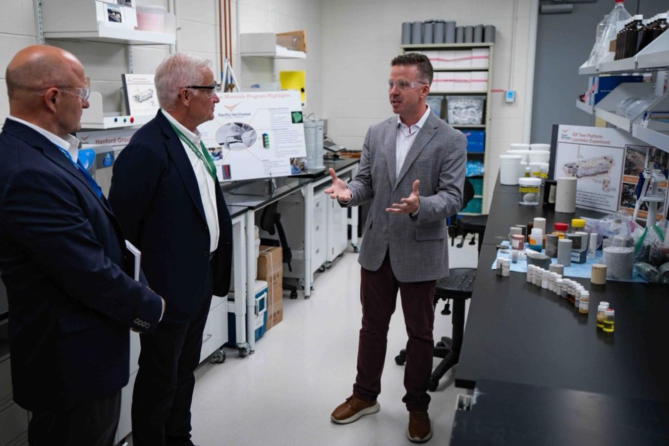 Three professionals tour a laboratory building