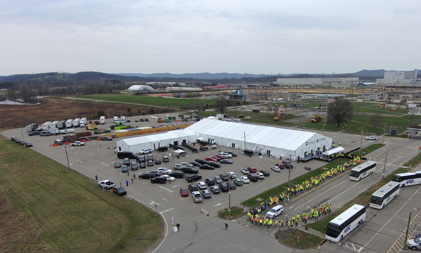 An aerial view of a large white tent set up in a parking lot at the Portsmouth Site