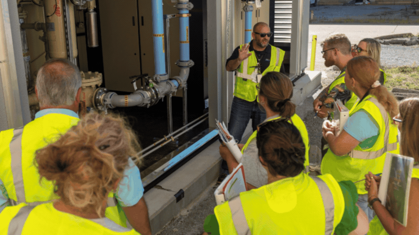 Rotating set of images of a group of teachers wearing yellow safety vests touring the Paducah Site with employees