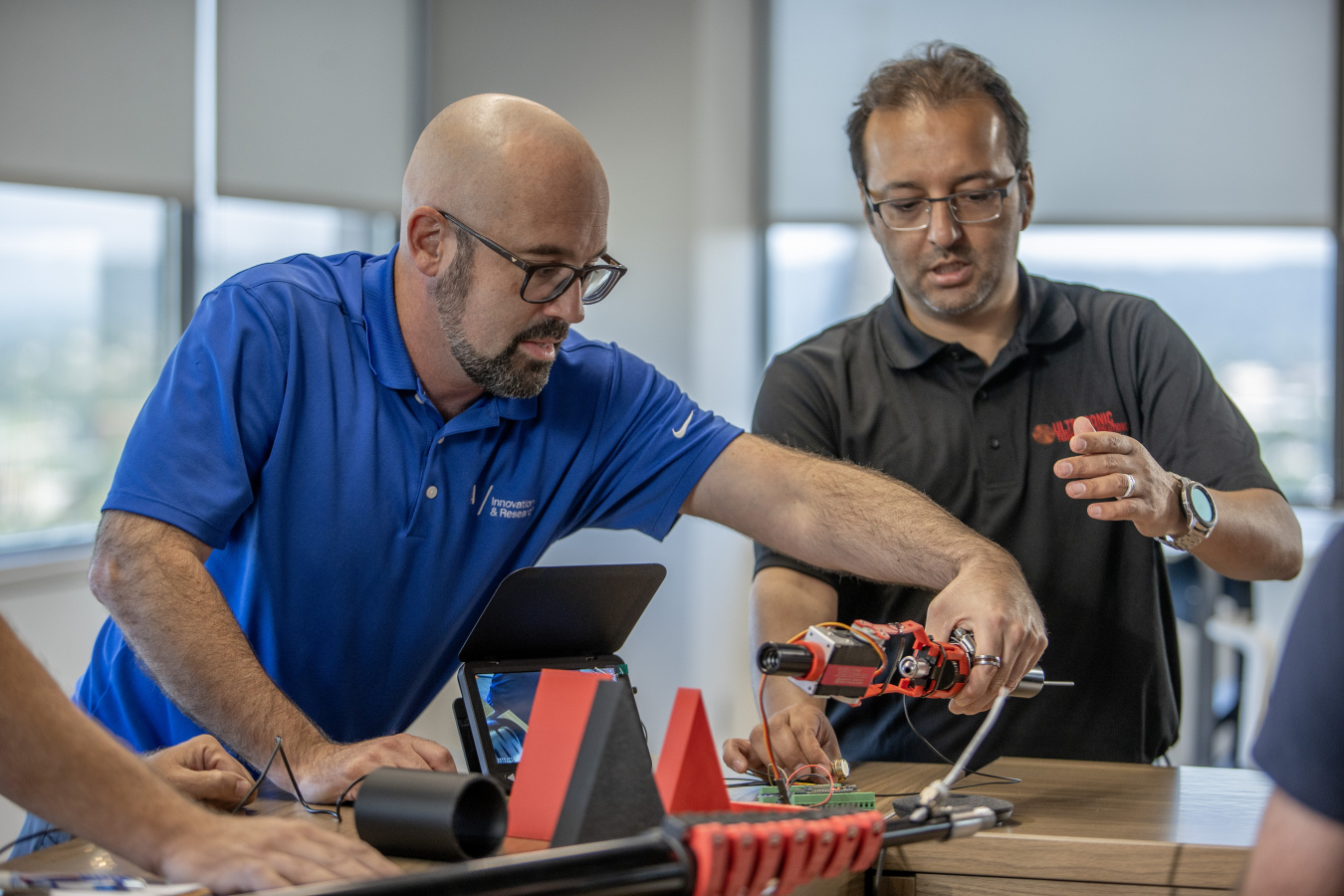 Curt Jawdy working on electronics in an office