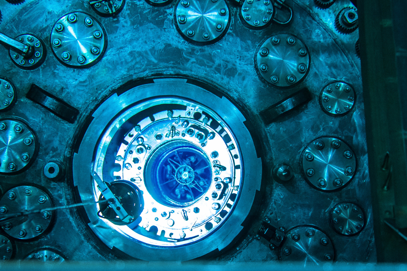 Blue glow from Cherenkov radiation illuminates the submerged reactor core of Oak Ridge National Laboratory’s High Flux Isotope Reactor during refueling.