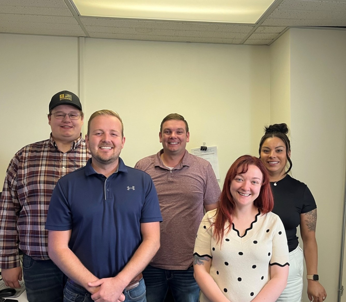 Five professionals and interns pose for photo together 