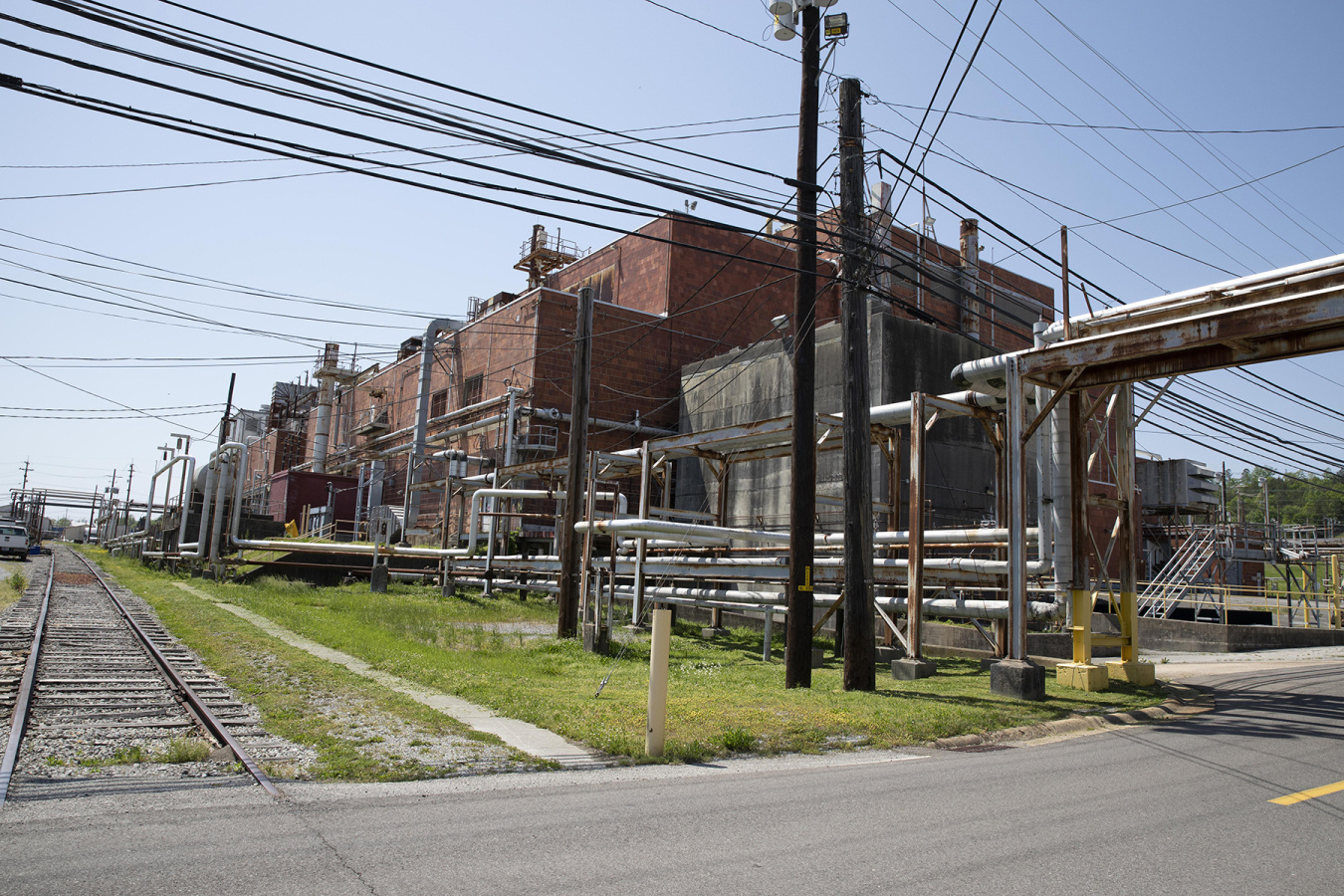 A large brick building at the Oak Ridge sites with lots of piping throughout