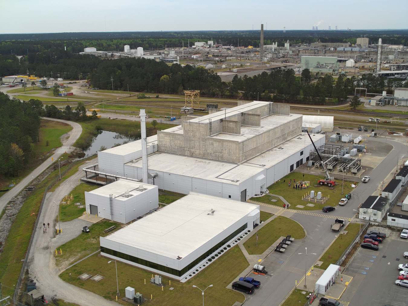 Aerial view of a large white facility building at SRS