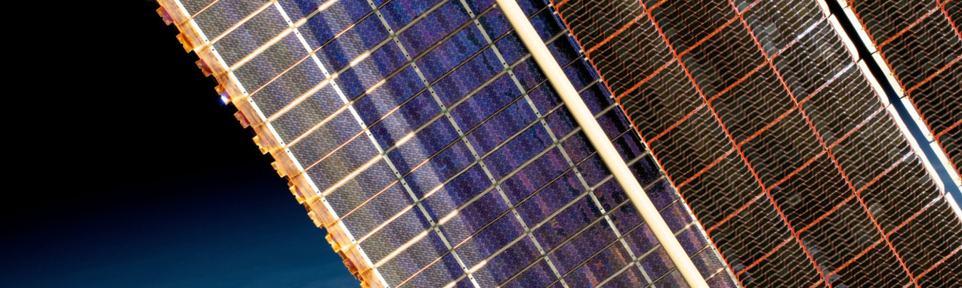 Legacy and roll-out solar arrays on the International Space Station illustrate the continuing evolution of space PV technology. Image from NASA