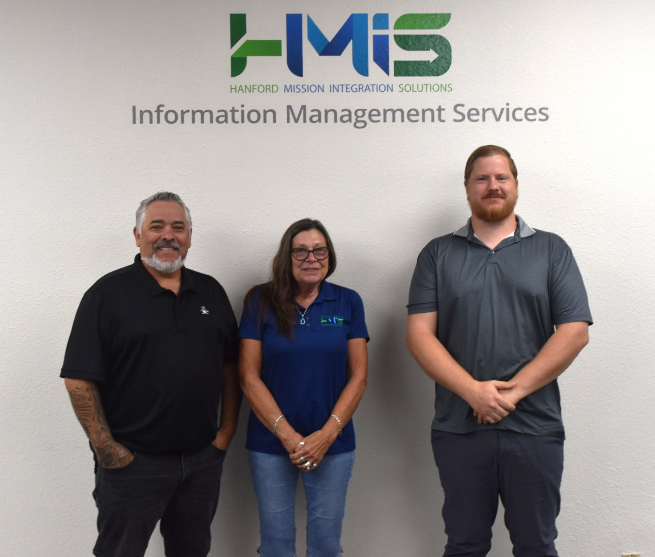 Three professionals pose for a photo together