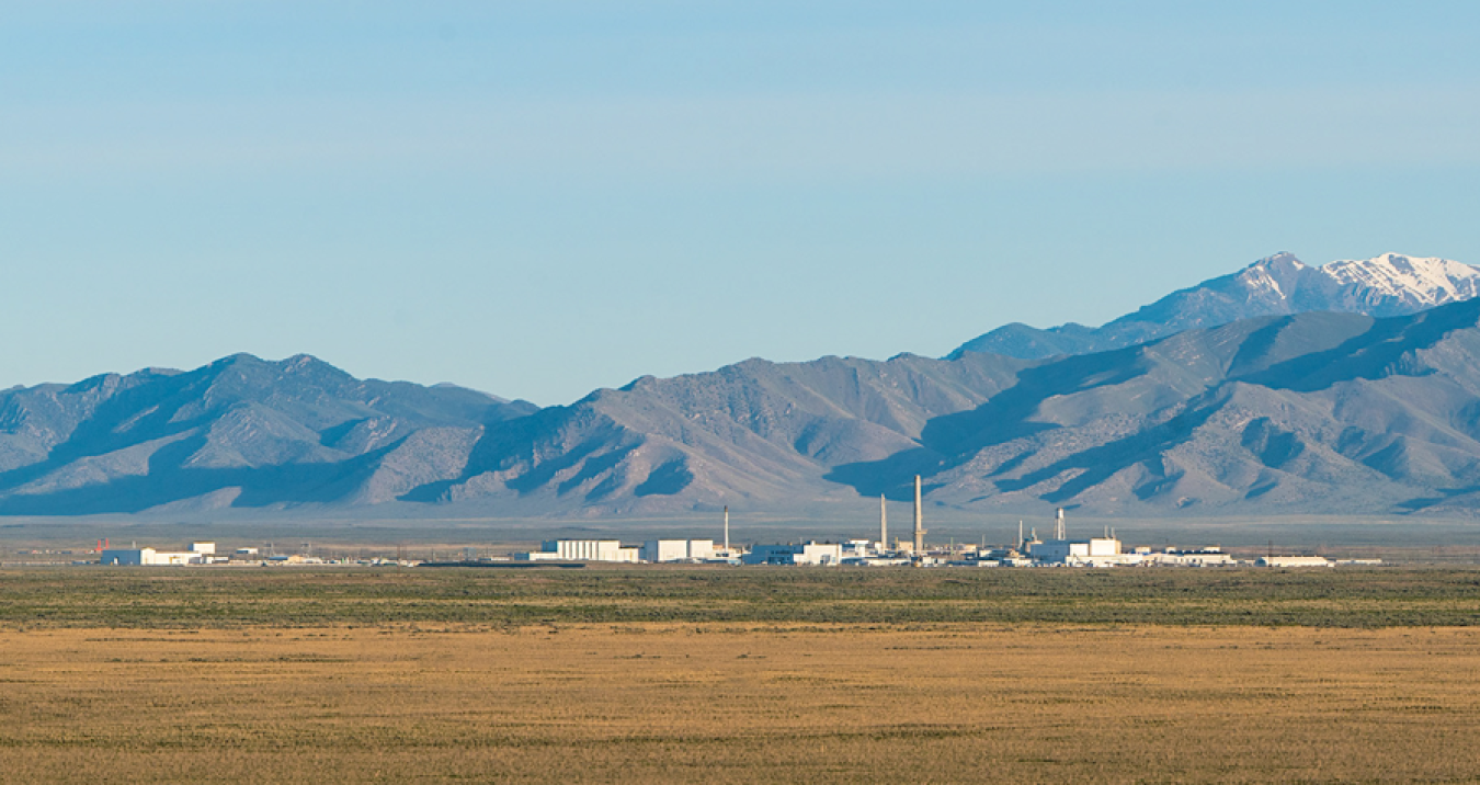 A landscape picture of mountains in the back ground in front of laboratory buildings