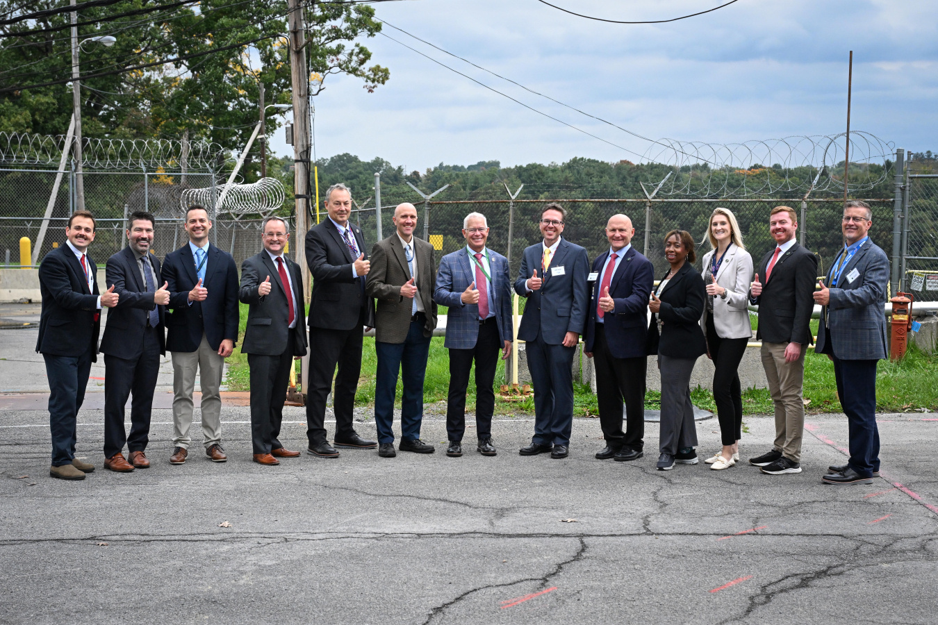A large group of professionals pose for a photo outside at the Knolls Lab