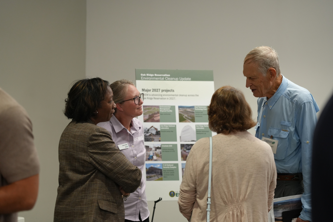 A group of professionals speaking to each other at a poster session