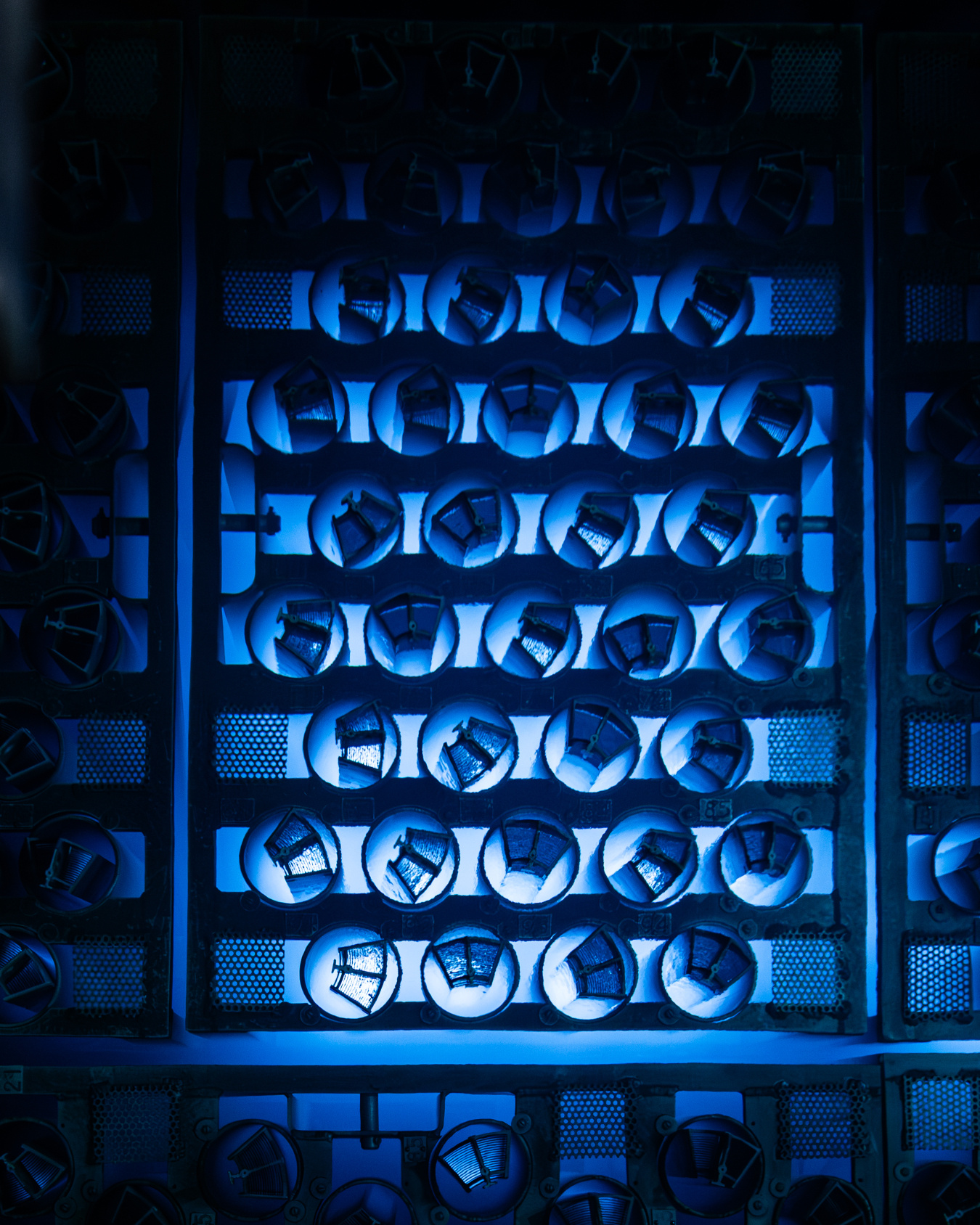 Nuclear fuel bundles arranged in a grid and emitting a blue glow