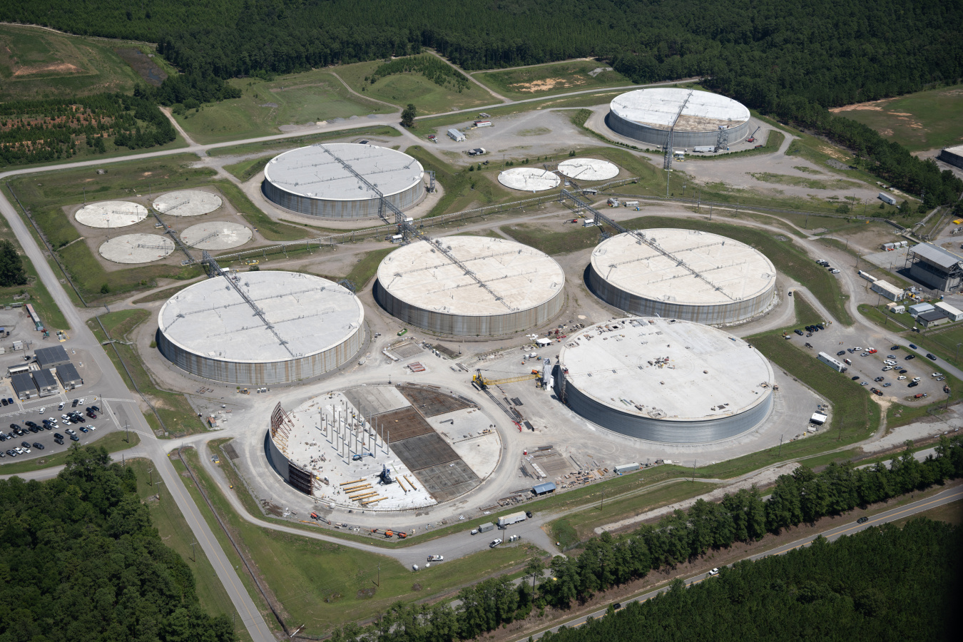 Aerial view of six large circular disposal unit buildings at the Savannah River Site