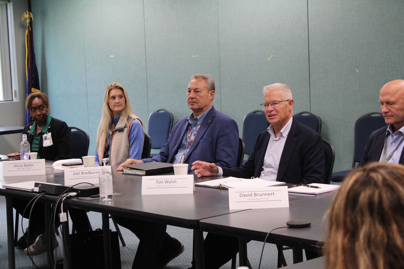 A group of EM leadership sitting at a table speaking on a panel