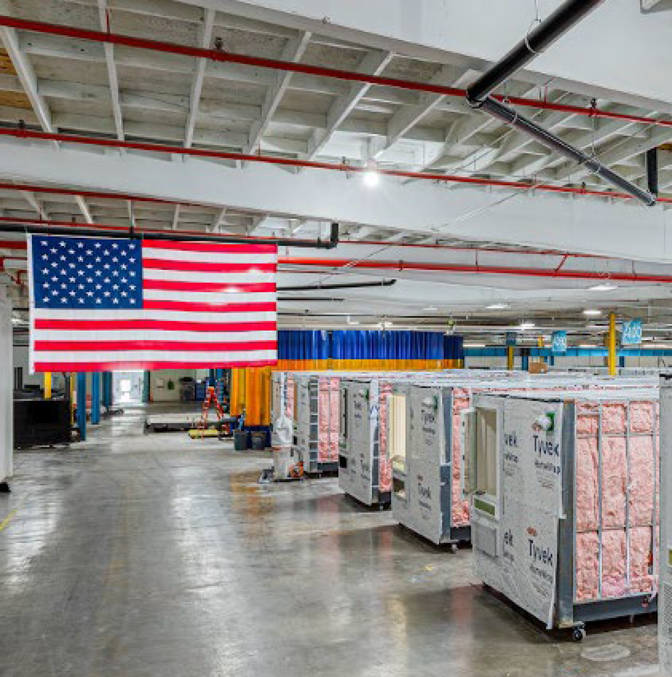 A warehouse of housing materials, with a U.S. flag hanging there.