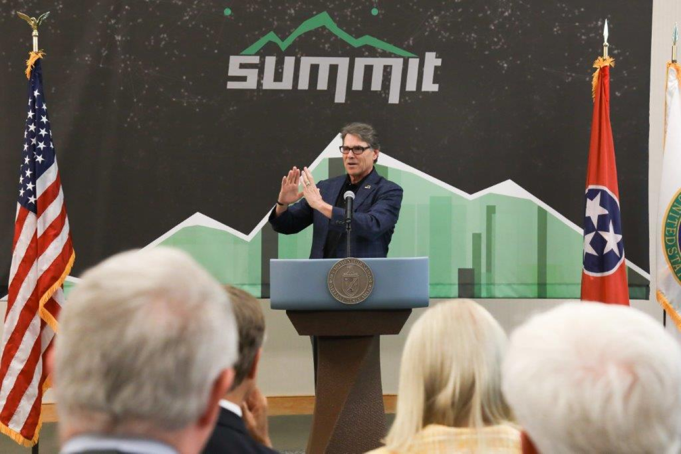 Rick Perry standing behind a 3D printed podium.