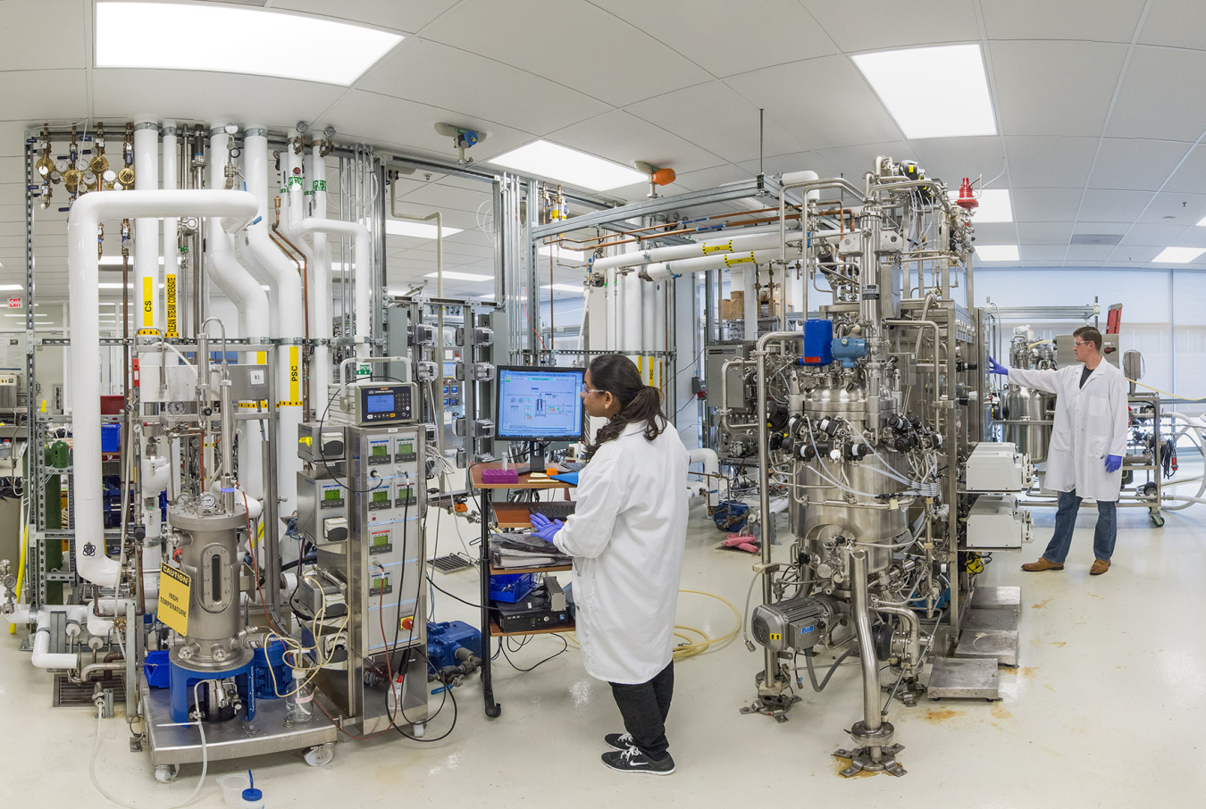 A researcher checks a computer monitor inside of the Advanced Biofuels Process Demonstration Unit at Lawrence Berkeley National Laboratory.