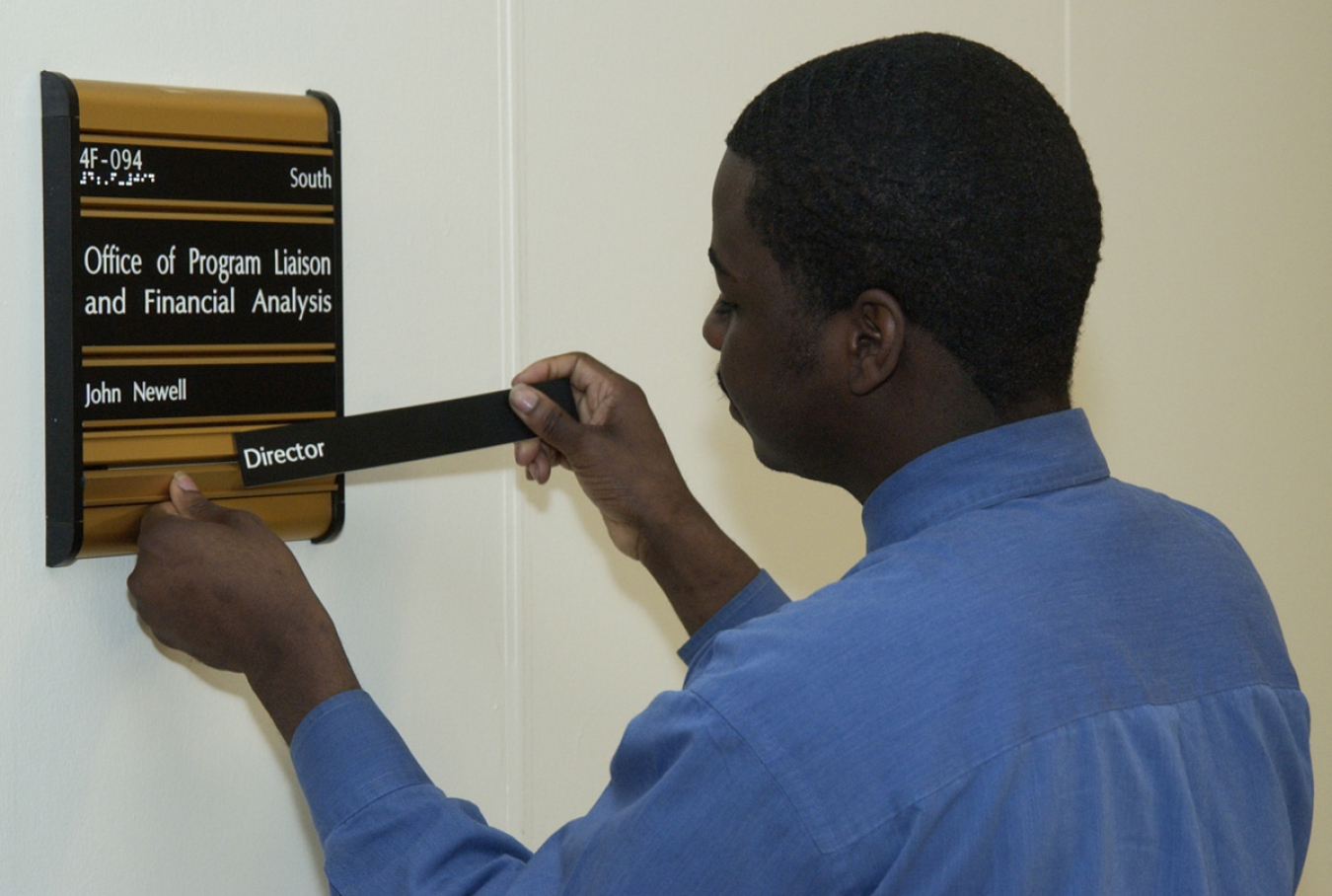 Technician replacing nameplate