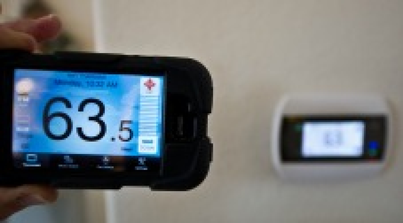 A digital thermostat that reads 63.5 degrees.