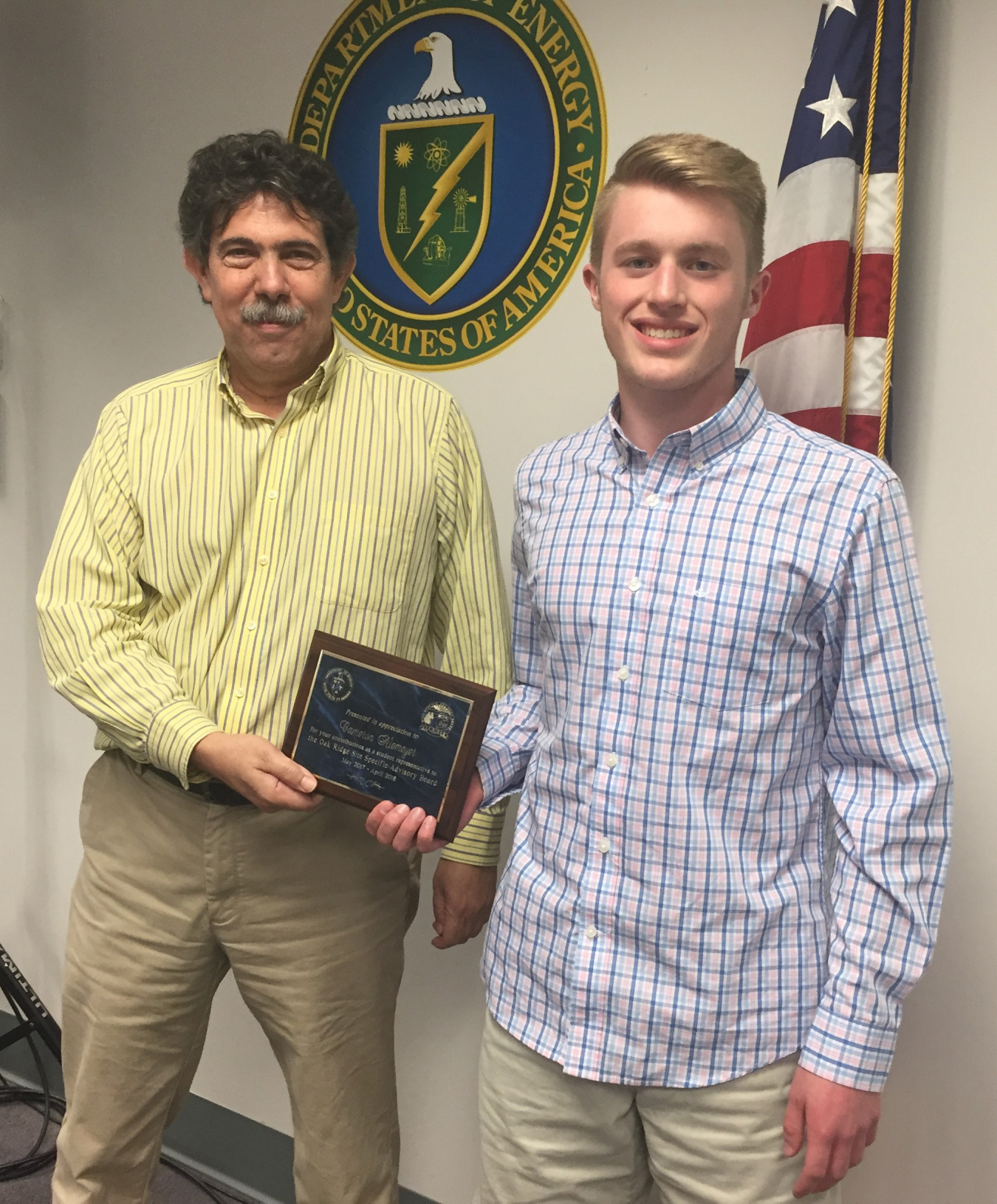 David Adler presents Cameron Niemeyer with plaque of appreciation